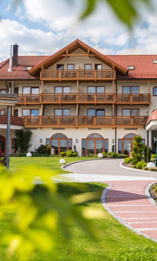 Die sommerliche Aussenansicht des Wellnesshotel Der Birkenhof bei Sonnenschein.