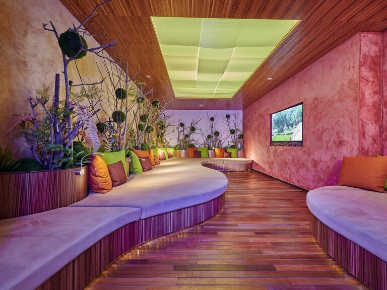Silence Room mit gemütlichen Liegegelegenheiten, Kissen, Pflanzendeko und einem Bildschirm